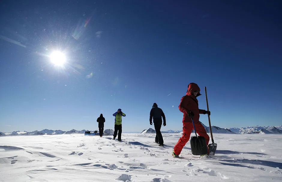 Researchers walking in the snow © Reuters