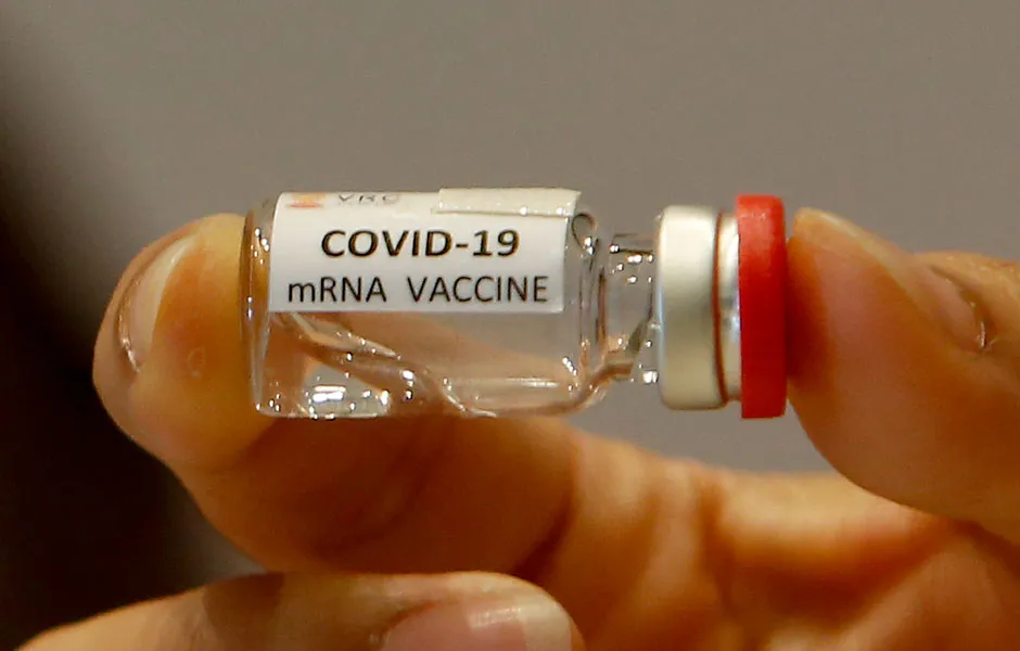 A small bottle labelled 'COVID-19 mRNA vaccine' © Getty Images