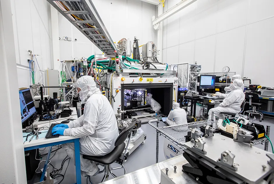 Engineers in a clean room at the SLAC National Accelerator Laboratory in California monitor and control the custom-built machinery and software used to carefully construct the focal plane © Jacqueline Orrell/SLAC