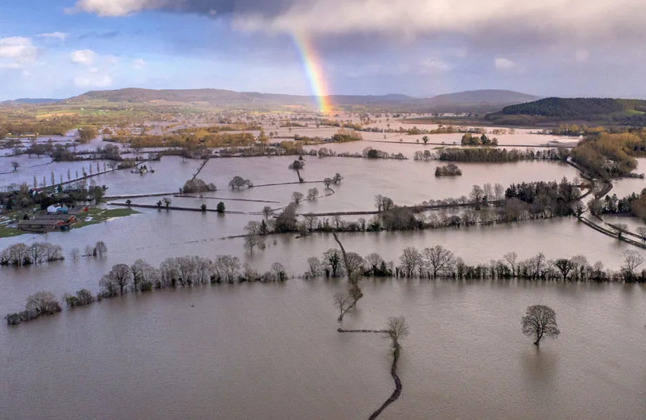 HEREFORD, ENGLAND - FEBRUARY 17: A rainbow appears over flooded fields in the Wye Valley, near the hamlet of Wellesley, following Storm Dennis on February 17, 2020 in Hereford, England. Storm Dennis is the second named storm to bring extreme weather in a week and follows in the aftermath of Storm Ciara. (Photo by Christopher Furlong/Getty Images)