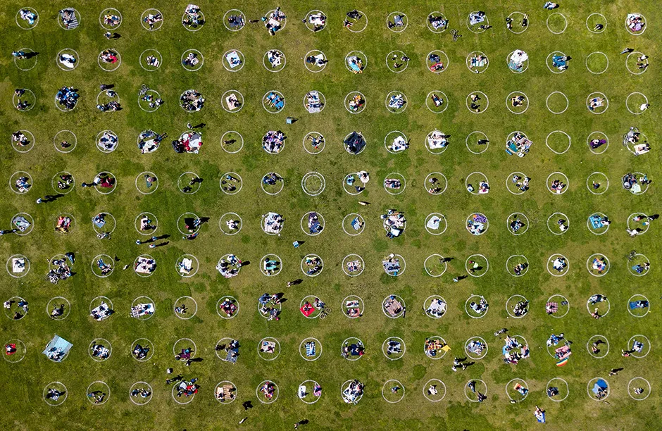TOPSHOT - An aerial view shows people gathered inside painted circles on the grass encouraging social distancing at Dolores Park in San Francisco, California on May 22, 2020 amid the novel coronavirus pandemic