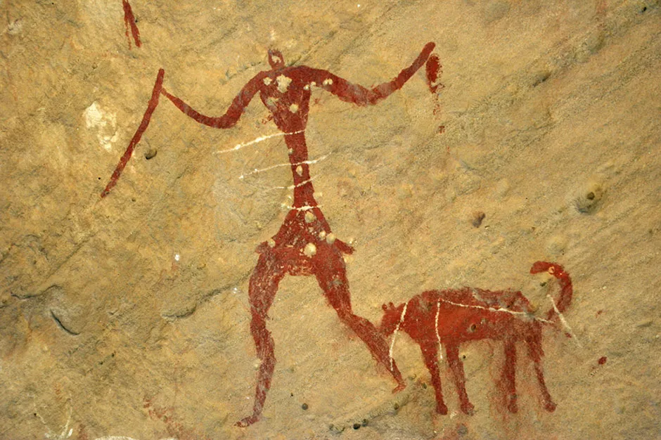 A cave painting of a human and a dog © Getty Images