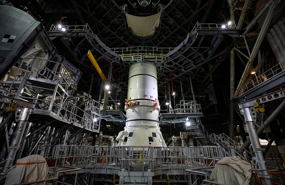The aft segments of the Space Launch System solid rocket boosters for the Artemis I mission moves from high bay 4 inside the VAB for stacking on the mobile launcher inside high bay 3.