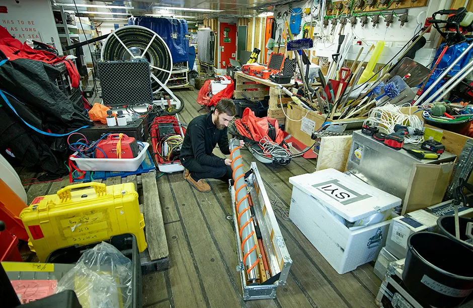 Steven Fons on work deck checking his ice core device during Leg 3 of the expedition. March 28, 2020