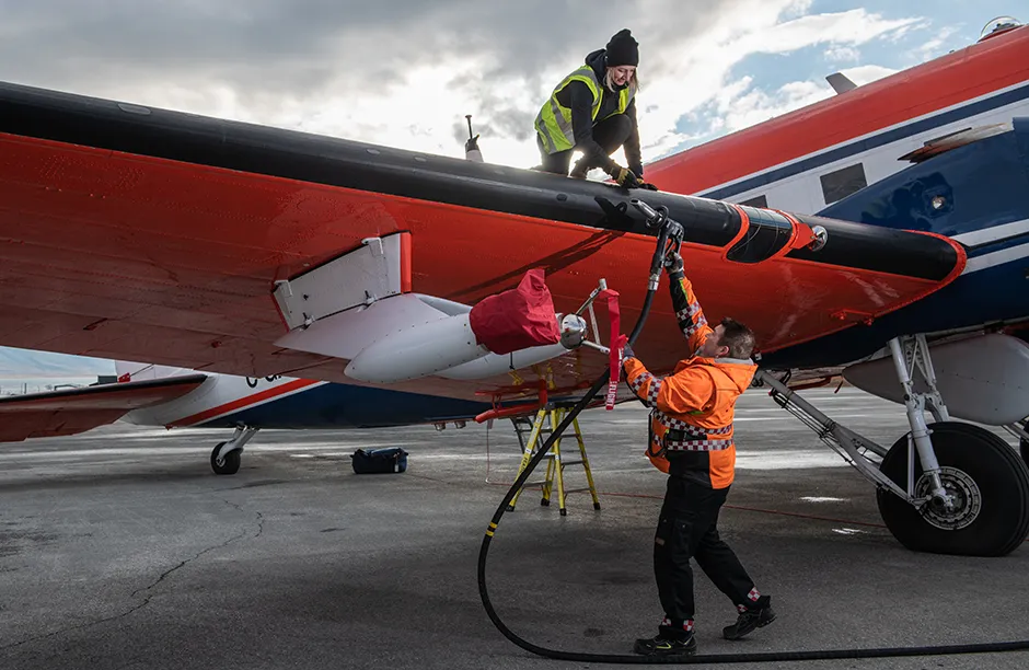 Michelle Anna Lacey, co-pilot of Polar 5 research aircraft fuels the airplane before taking off at the airport of Longyearbyen.