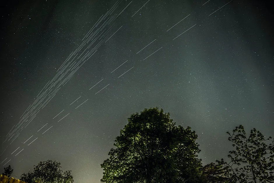 Long camera exposures reveal the trails of Starlink satellites visible in the night sky © Alamy