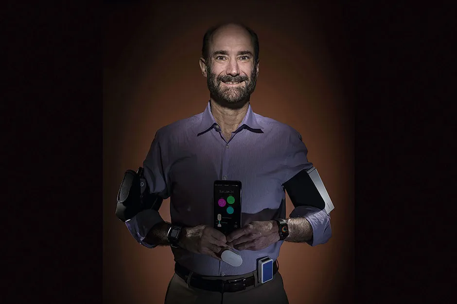 Study leader Prof Michael Snyder with several wearable health devices © Steve Fisch/Stanford University