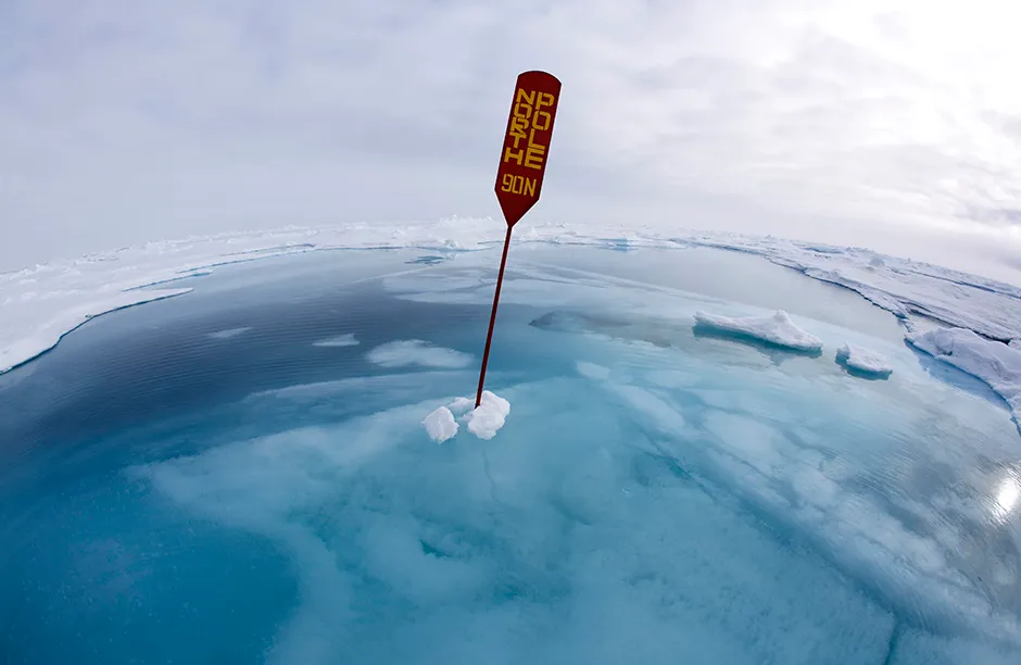 North Pole sign in melting ice and meltwater