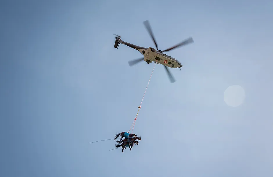 A picture taken on April 9, 2021 in Saignelegier shows three horses being airlifted together during a test by Swiss army forces on hoisting horses with a helicopter. - The scientific project, carried out by the Vetsuisse faculty of veterinary medicine and the Swiss army veterinary service, aims at transporting and rapidly evacuating injured horses to a medical veterinary infrastructure. (Photo by Fabrice COFFRINI / AFP) (Photo by FABRICE COFFRINI/AFP via Getty Images)