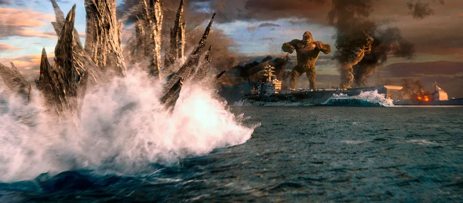 Godzilla swimming towards Kong, who is standing on a boat © Warner Brothers Pictures