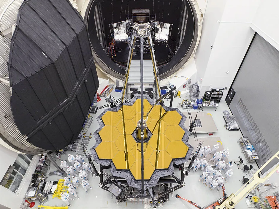 Engineers pose with the JWST after it emerges from 100 days of cryogenic testing inside Chamber A at NASA’s Johnson Space Center in Houston. All parts of the JWST were subjected to rounds of cryogenic testing to ensure they could withstand the extreme cold of space © NASA/Goddard Space Flight Centre
