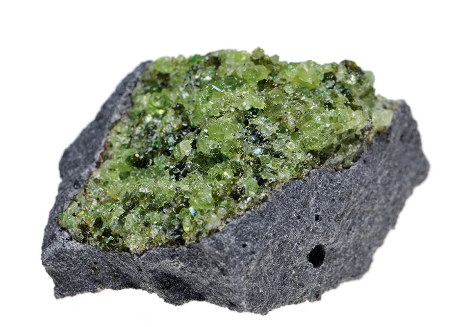 Crystals of the mineral olivine on a chunk of basalt © Alamy