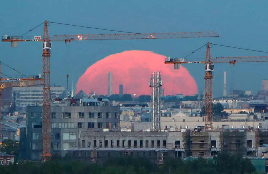 ST PETERSBURG, RUSSIA - MAY 26, 2021: A reddish full moon rises over St Petersburg at dusk. Peter Kovalev/TASS (Photo by Peter KovalevTASS via Getty Images)