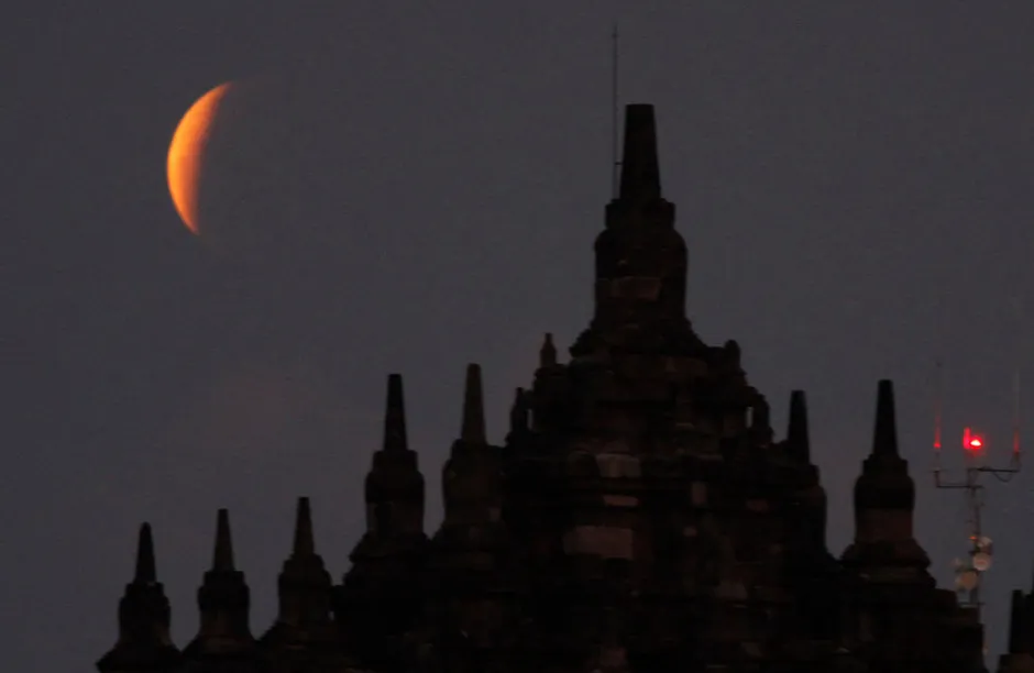 A total lunar eclipse that coincides with the celebration of Vesak Day, on May 26,2021 observed from the area of Plaosan Temple, Prambanan, Klaten, Central Java, Indonesia. The total lunar eclipse which is also a super blood moon and coincides with the commemoration of Vesak Day is a rare phenomenon that can only occur in a few decades, let alone a total lunar eclipse that coincides with the commemoration of Vesak Day 2565 like today. ''What coincides with this Vesak is also (rare), maybe hundreds of years from now there will be a super blood moon (super red moon) which coincides with Vesak Day. (Photo by Dasril Roszandi/NurPhoto via Getty Images)