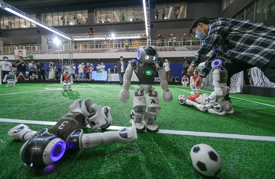 Robot soccer players compete in a soccer game during the 2021 RoboCup China Open, also the RoboCup Asia-Pacific (RCAP) Tianjin Invitation Tournament, which is a part of the fifth World Intelligence Congress, at Tianjin Konggang Sports Center on May 21, 2021 in Tianjin, China. (Photo by Tong Yu/China News Service via Getty Images)