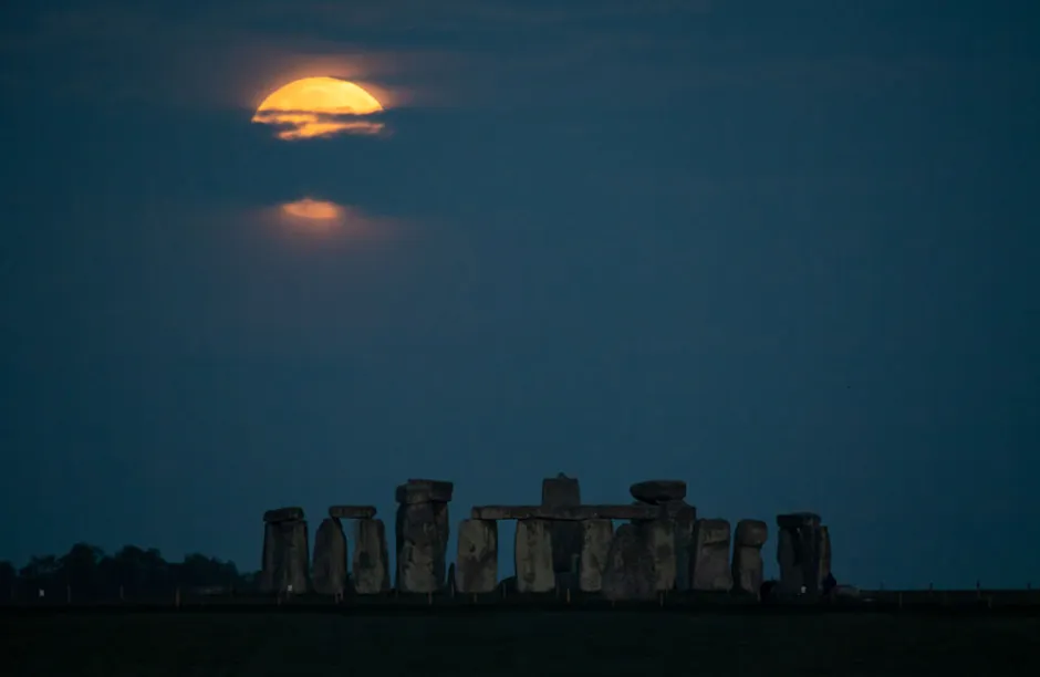 The Flower Moon sets over Stonehenge on May 26, 2021 in Amesbury, United Kingdom. May’s full moon, the “Flower Moon
