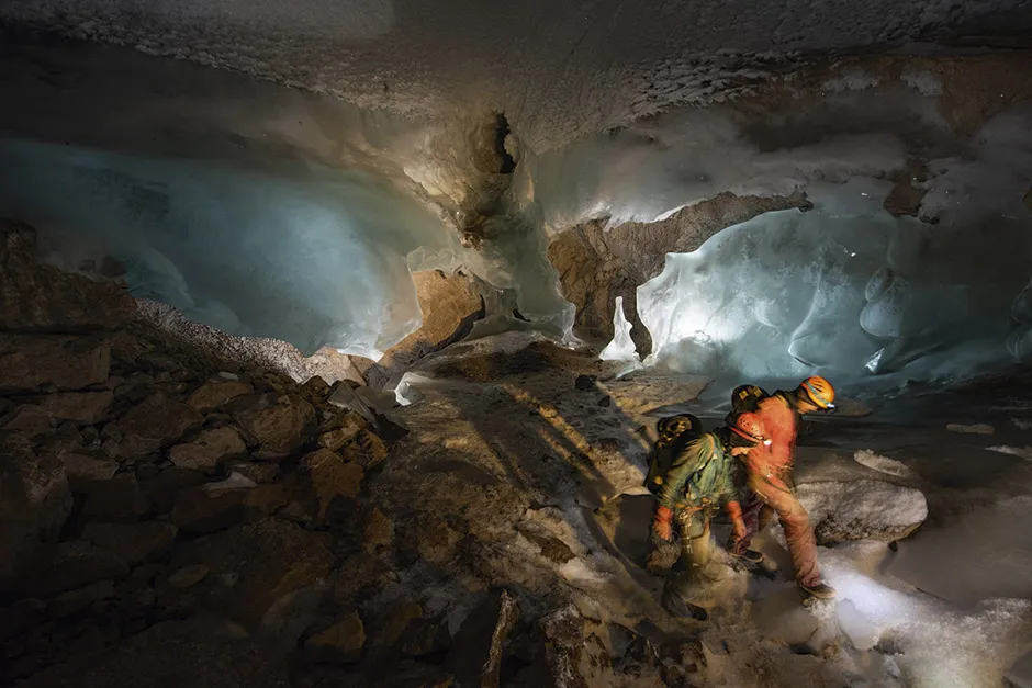 Two members of the team inside the cave, surrounded by blue ice © Robbie Shone
