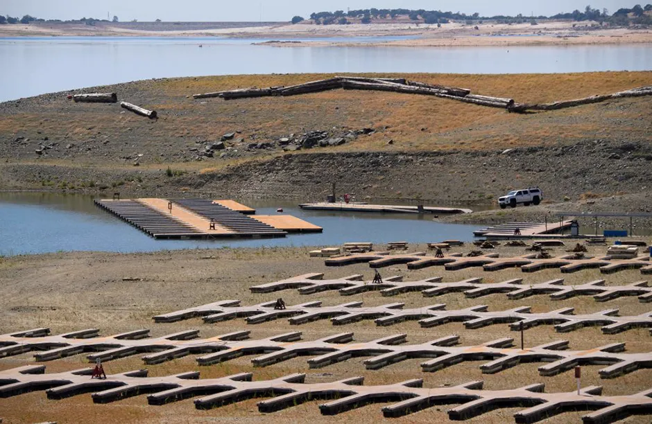 Empty boat slips sit on a dry lake bed at Folsom Lake Marina as the lake experiences lower water levels during the California drought emergency on May 27, 2021 in El Dorado Hills, California. - On May 10, California Governor Gavin Newsom declared a state of drought emergency in 41 counties, including El Dorado County where Folsom Lake is located. (Photo by Patrick T. FALLON / AFP) (Photo by PATRICK T. FALLON/AFP via Getty Images)
