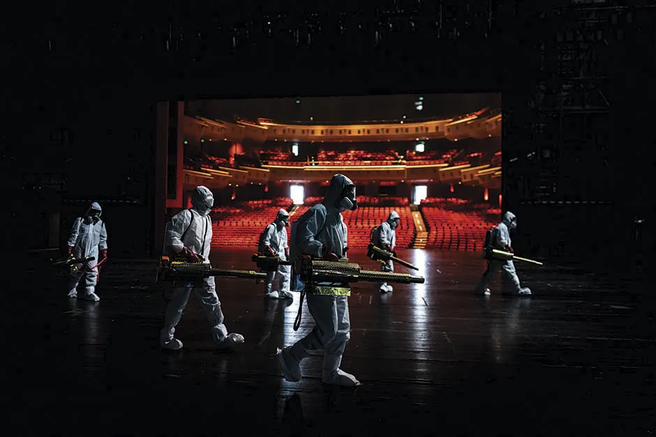 The Time of Coronavirus by Aly Song. Volunteers from the Blue Sky Rescue Team, the largest humanitarian NGO in China, are pictured disinfecting the Qintai Grand Theatre in Wuhan, near to where the COVID-19 pandemic began © Aly Song/Wellcome Photography Prize 2021