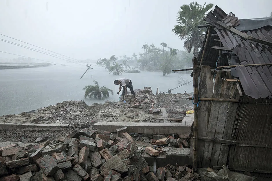 A man named Haibur is salvaging belongings from the wreckage of his house, three months after Cyclone Amphan hit Bangladesh © Zakir Hossain Chowdhury/Wellcome Photography Prize 2021