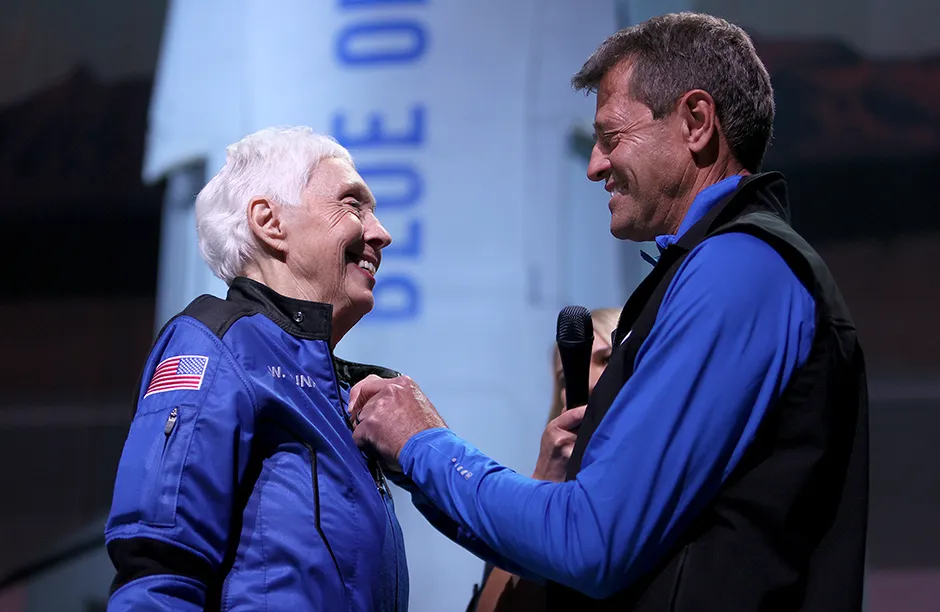 VAN HORN, TEXAS - JULY 20: Wally Funk receives astronaut wings from Blue Origin’s Jeff Ashby, a former Space Shuttle commander, after her flight on Blue Origin’s New Shepard into space on July 20, 2021 in Van Horn, Texas. Ms. Funk and the crew that flew with her were the first human spaceflight for the company. (Photo by Joe Raedle/Getty Images)