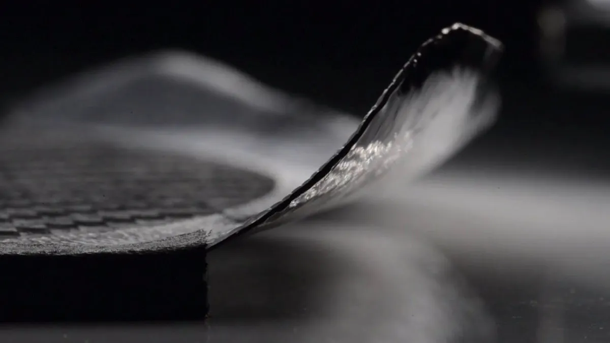 A thin sheet of carbon fibre bending into a wing shape © Carmel Snow