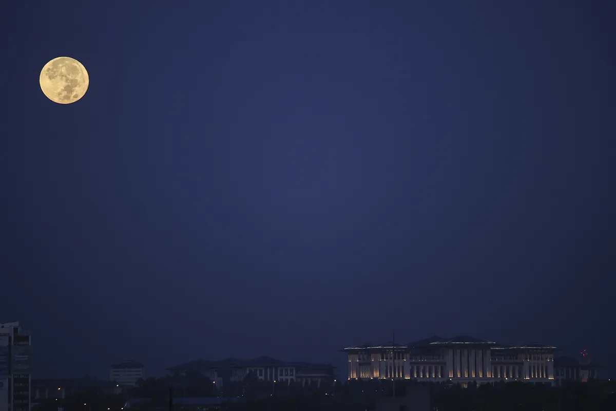 ANKARA, TURKEY - SEPTEMBER 21: Full Moon is seen with the Presidential Complex, at early morning hours in Ankara, Turkey on September 21, 2021. (Photo by Dogukan Keskinkilic/Anadolu Agency via Getty Images)