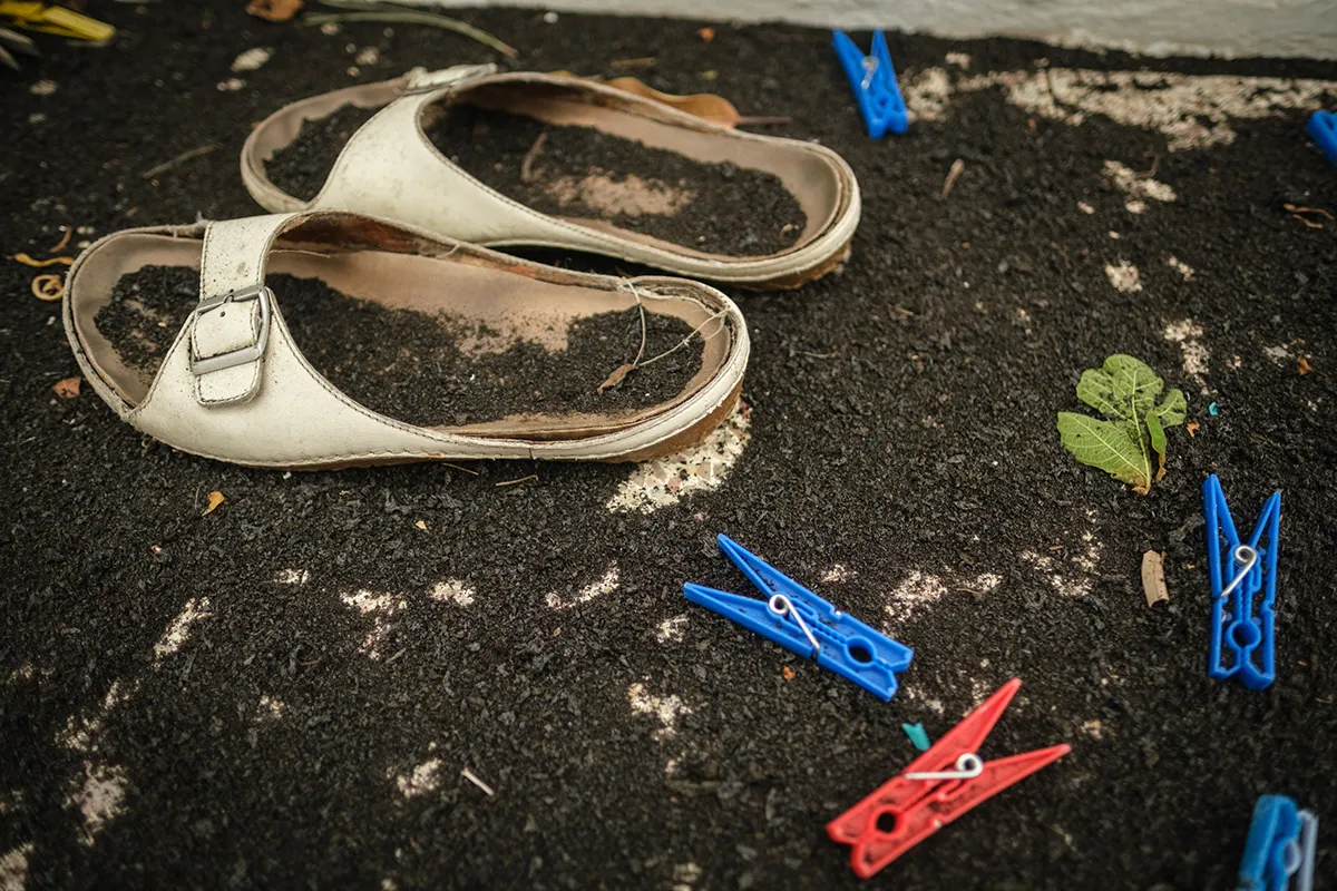 EL PASO, SPAIN - SEPTEMBER 21: Flip flops covered in ash during an evacuation process as Mount Cumbre Vieja continues to erupt in El Paso, spewing out columns of smoke, ash and lava on the Canary island of La Palma on September 21, 2021. The volcanic eruption on the Spanish Canary Island of La Palma has destroyed around 100 homes, large swathes of agricultural land, roads and businesses, officials said on Monday. (Photo by Andres Gutierrez/Anadolu Agency via Getty Images)
