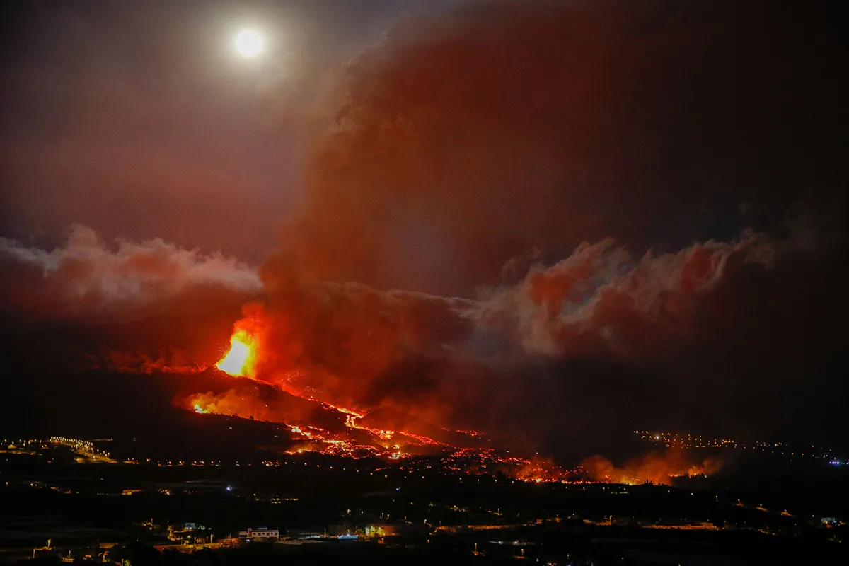 LA PALMA, SANTA CRUZ DE TENERIFE, SPAIN - SEPTEMBER 21: An eruptive mouth expels lava and pyroclasts in the area of Los Llanos, on 20 September 2021, in El Paso, La Palma, Santa Cruz de Tenerife, Canary Islands, Spain. The volcanic eruption began yesterday at 16 hours in the area of Cabeza de Vaca (La Palma), just when seismic activity on the island of La Palma had reached the maximum since the beginning of the swarm a week ago, is currently with two fissures, separated about 200 meters, and eight mouths through which lava emerges. At least 15 homes are affected by the eruption early Monday and more than 5,000 people have been evacuated so far. Experts do not know when this eruption will end, which has left temperatures of 1,075 ° C in the rivers of lava from the volcano. (Photo By Kike Rincon/Europa Press via Getty Images)
