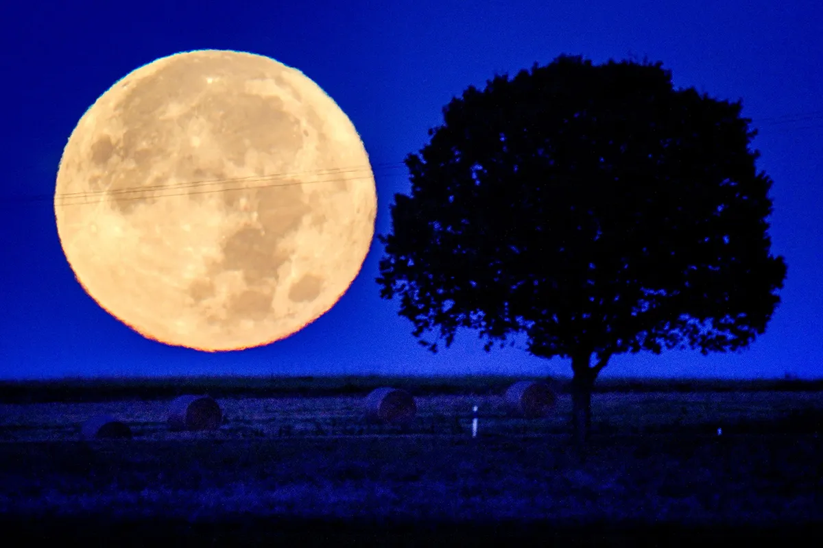 Mandatory Credit: Photo by Michael Probst/AP/Shutterstock (12455347a) The full moon sets behind the hills of the Taunus region near Wehrheim, Germany, early Tuesday, Sept.21, 2021 Moon, Wehrheim, Germany - 21 Sep 2021