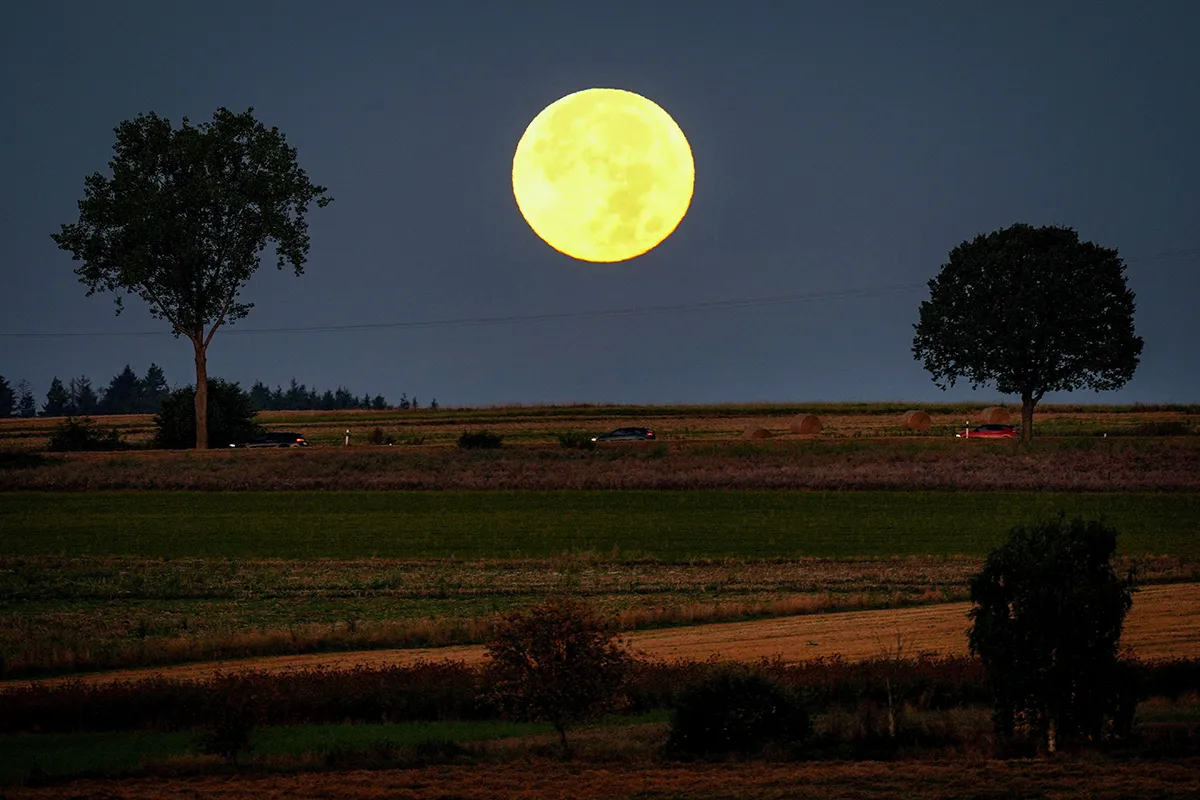 Mandatory Credit: Photo by Michael Probst/AP/Shutterstock (12455347b) The full moon sets behind the hills of the Taunus region near Wehrheim, Germany, early Tuesday, Sept.21, 2021 Moon, Wehrheim, Germany - 21 Sep 2021