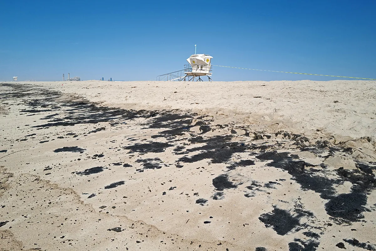 HUNTINGTON BEACH, CALIFORNIA - OCTOBER 03: Oil is washed up on Huntington State Beach after a 126,000-gallon oil spill from an offshore oil platform on October 3, 2021 in Huntington Beach, California. The spill forced the closure of the popular Great Pacific Airshow with authorities urging people to avoid beaches in the vicinity. (Photo by Nick Ut/Getty Images)