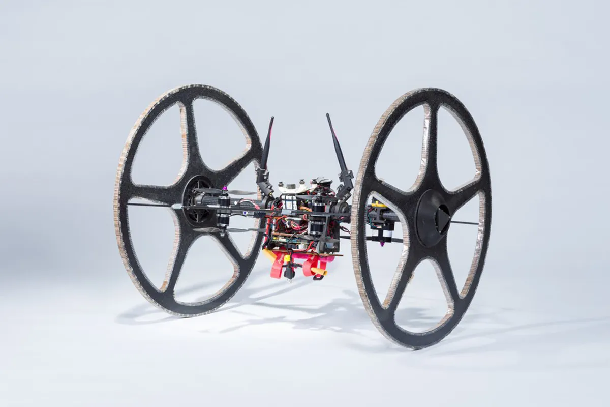Rollocopter, a hybrid aerial and terrestrial platform, uses a quadrotor system to fly or roll along on two passive wheels. This design gives the robot greater range than aerial-only quadrotors and eliminates obstacle-avoidance issues associated with ground-only robots. When Rollocopter encounters an obstacle, it can simply fly over it. To fly this robot requires a celestial body with an atmosphere and could be used to explore subterranean caves other worlds. Photo by NASA/JPL