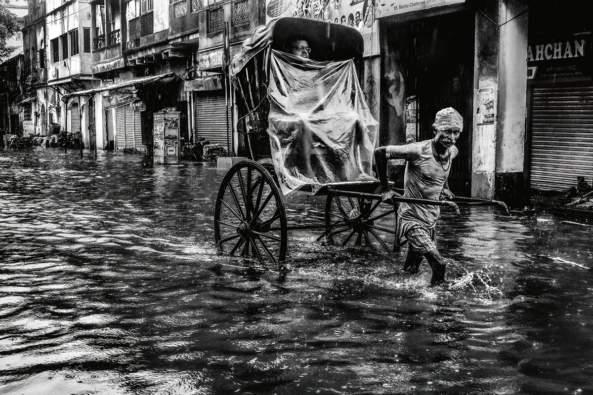 A hand-pulled rickshaw struggles through the flooded streets of Kolkata during the monsoon season. Although the Indian Monsoon occurs with a fairly regular seasonal cycle, significant variations can occur in the intensity and timing of the monsoon rains from year to year. Where monsoon rains fail, the results can be catastrophic. Although crops require the monsoon rains in order to grow, excess rainfall can be really problematic, creating widespread flooding that can displace millions of people. The most dangerous flooding events in the region are often associated with landfalling tropical storms in the Bay of Bengal. In May 2020, an exceptionally powerful tropical storm called Cyclone Amphan struck Bangladesh and eastern parts of India, with sustained wind speeds of over 240 kph (150 mph). A storm surge and exceptionally heavy rainfall combined to create widespread flooding. In Kolkata, 240 mm (9 in) of rain was recorded. Photo by Debarshi Mukherjee