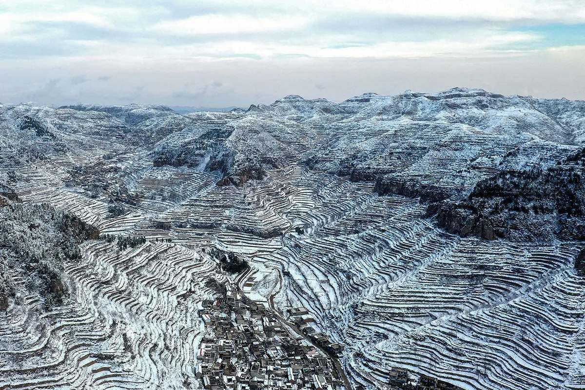 This aerial photo taken on 7 November 2021 shows terraced fields after a snowfall in Handan in China's northern Hebei province. - China OUT (Photo by AFP) / China OUT (Photo by STR/AFP via Getty Images)