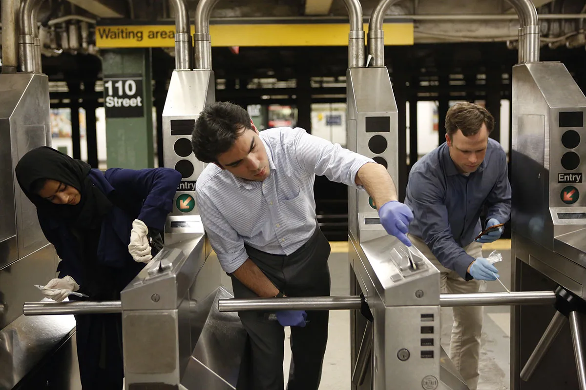 Prof Christopher Mason and colleagues swabbing ticket barriers at a subway station © Getty Images