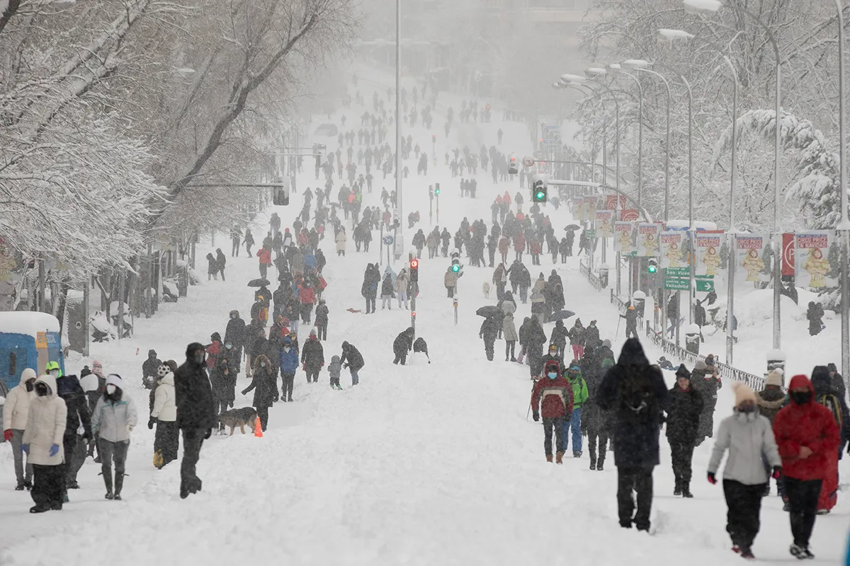 People walk on the snow along Calle de Segovia Spain