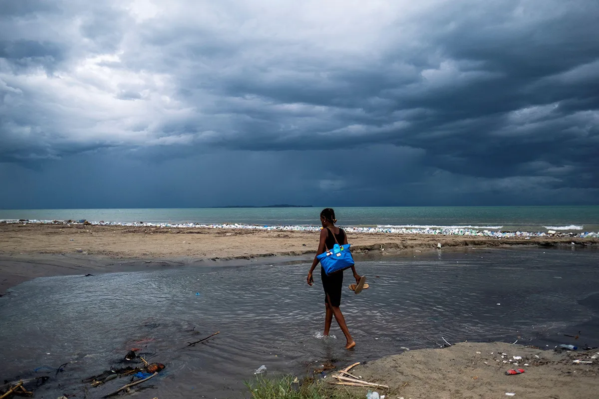 Woman in beach Haiti As storm approaches