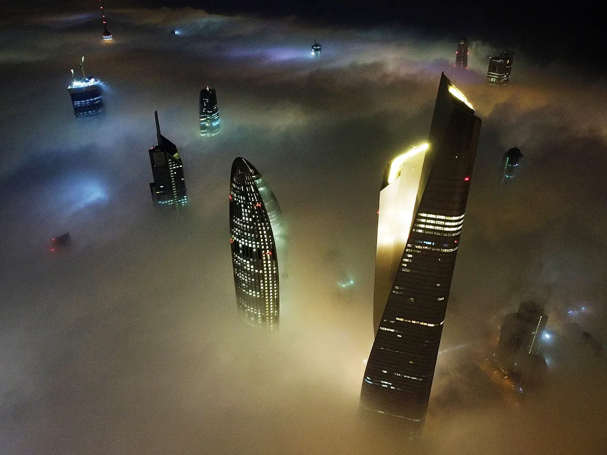 Buildings rising above Fog