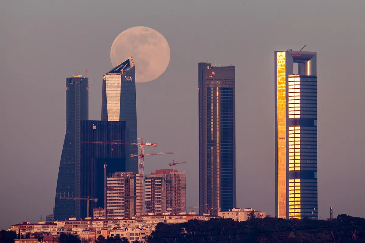 The full Moon of January known as Wolf Moon rises over the skyscrapers of the Four Towers Business Area of Madrid. (Photo by Marcos del Mazo/LightRocket via Getty Images)