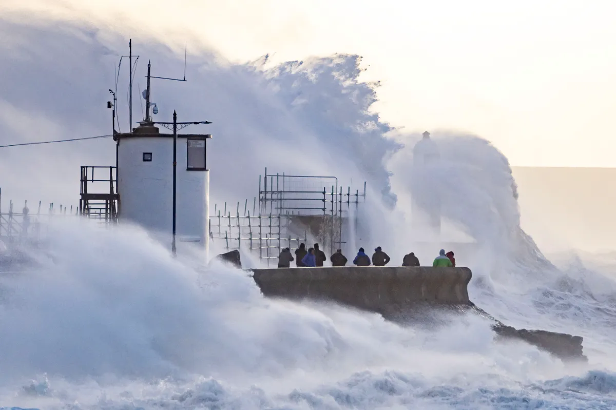 Waves batter a harbour wall in Porthcawl, Wales © Getty Images