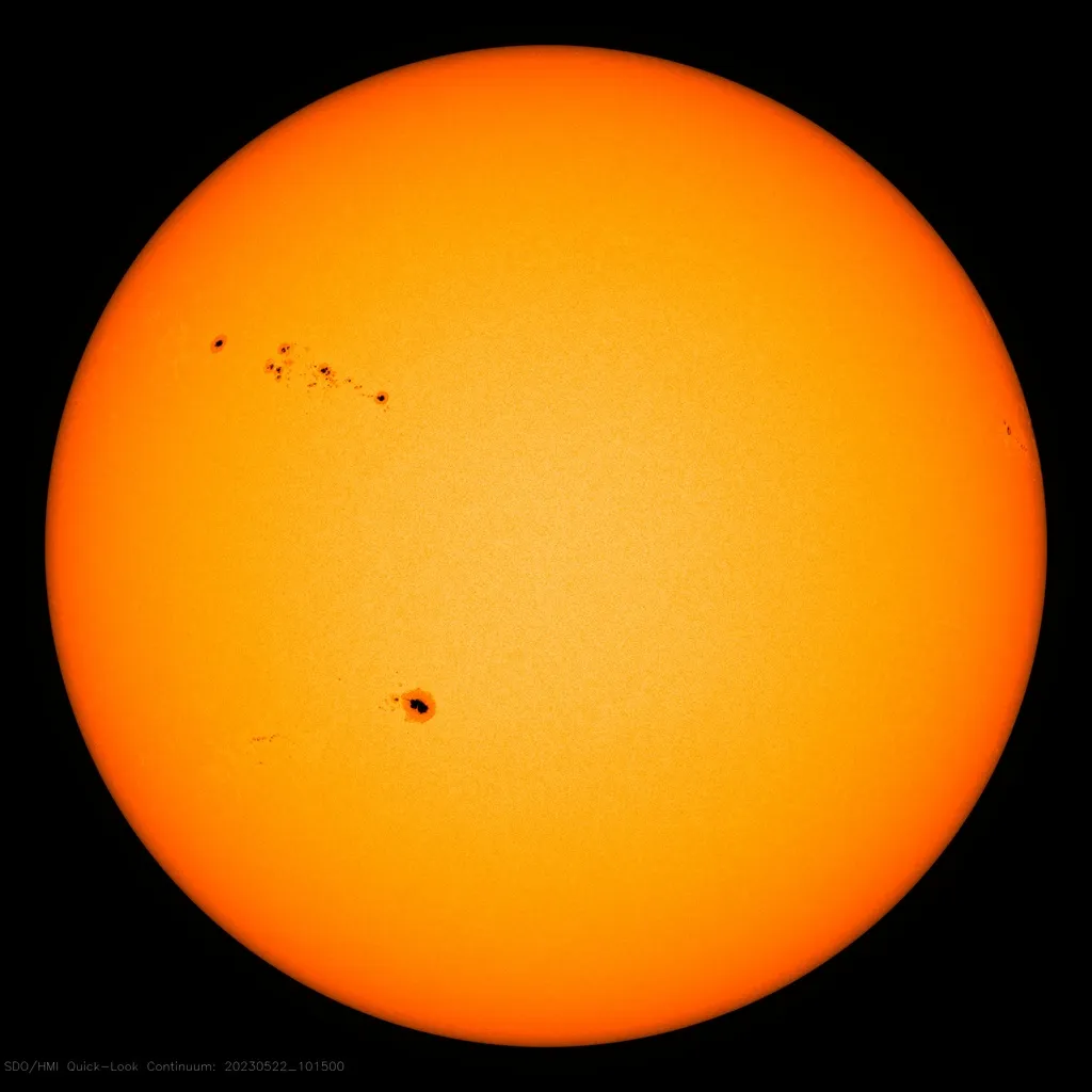 The Sun as it is in May 2023. You can just make out the black centre of the sunspots (the umbra) surrounded by a lighter, grey area (the penumbra) Image Credit: NASA