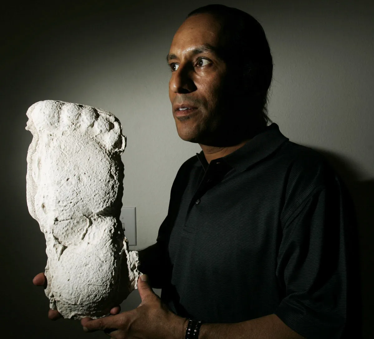 Bigfoot believer Daniel Perez holding foot cast