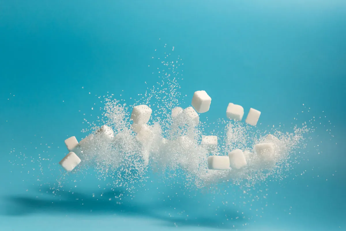 White sugar and cubes flying