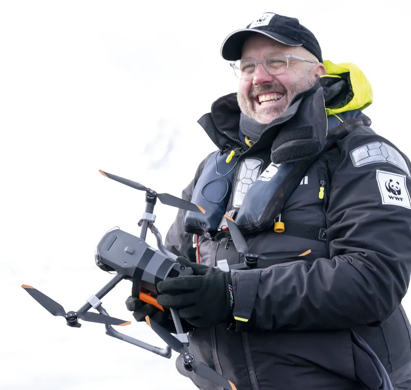 Man holding a drone in the Antarctic