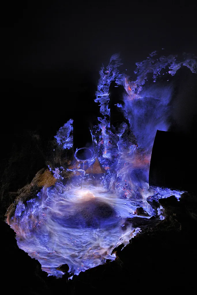Blue lava, gasses and flames swirl round tinged with white hot and pink colours