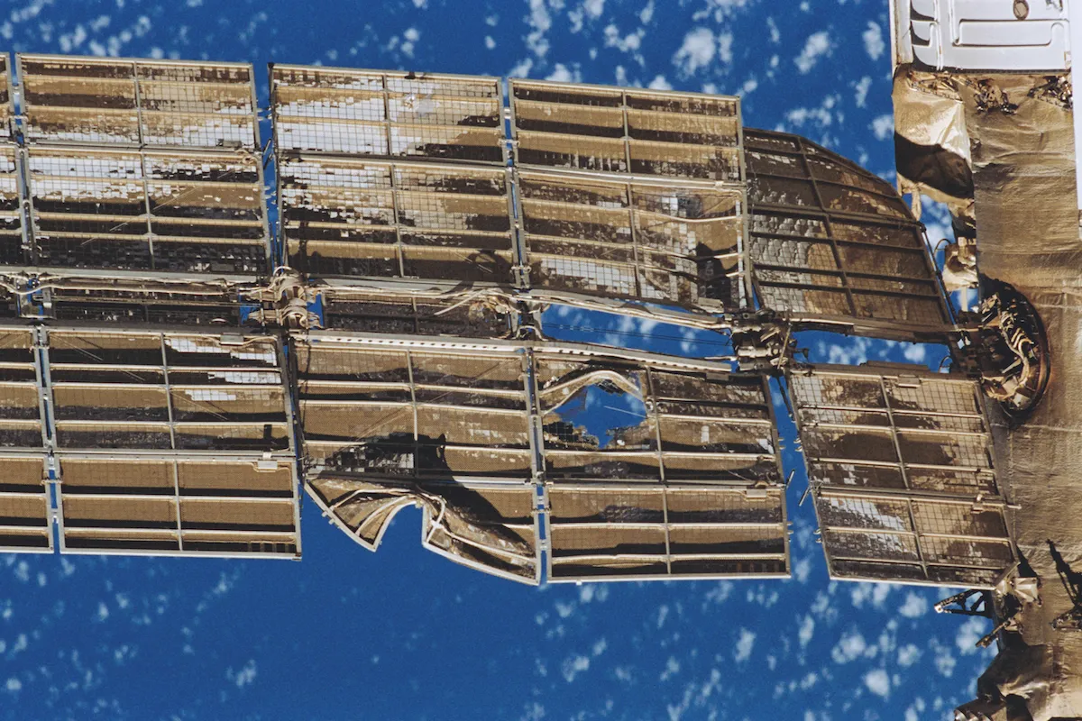 A damaged solar array in the Mir space station after it was hit by a satellite.