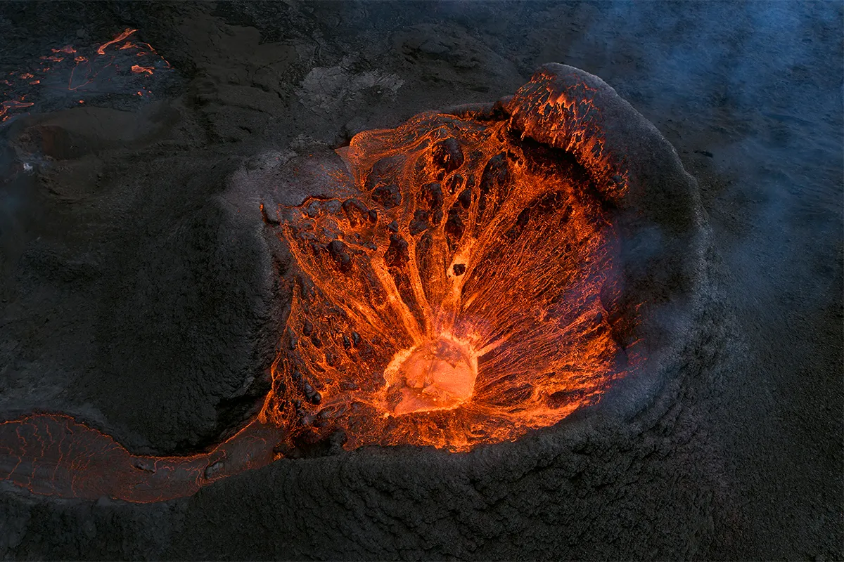 aerial view of crater with lava