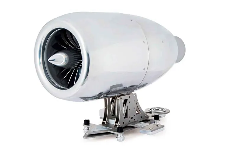 A small replica of a jet engine sits in front of a white background. The jet engine can produce coffee.