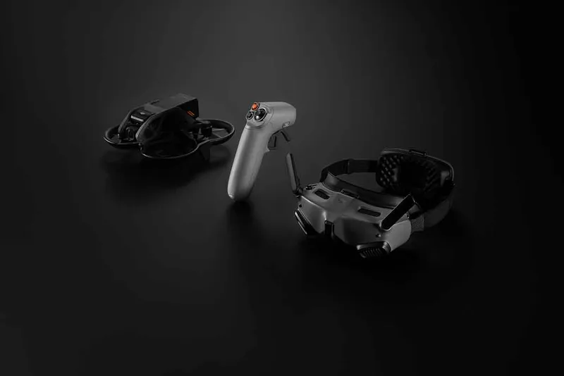 The DJI Avata headset sat on a black background next to the controller and headset